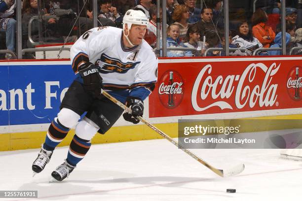 Calle Johansson of the Washington Capitals skates with the puck during a NHL hockey game against the looks on during a NHL hockey game at MCI Center...