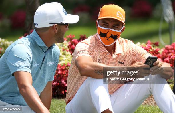 Andrew Landry of the United States and Rickie Fowler of the United States wait to watch the finish near the 18th green during the final round of the...