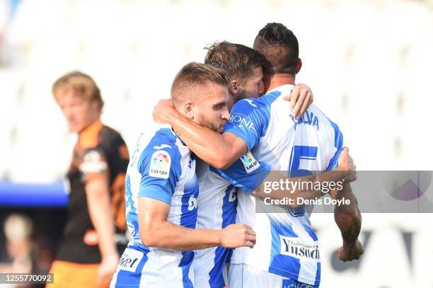 Ruben Perez of Leganes celebrates with teammates Kevin Rodrigues and Jonathan Silva of Leganes after scoring his team's first goal from the penalty...