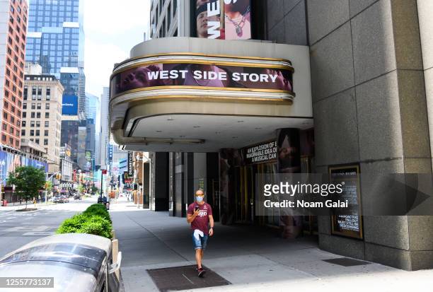Person wears a protective face mask outside the West Side Story musical at the Broadway Theatre as New York City moves into Phase 3 of re-opening...