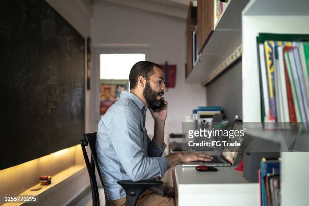 men talking on the phone while working from home - ordinary guy stock pictures, royalty-free photos & images