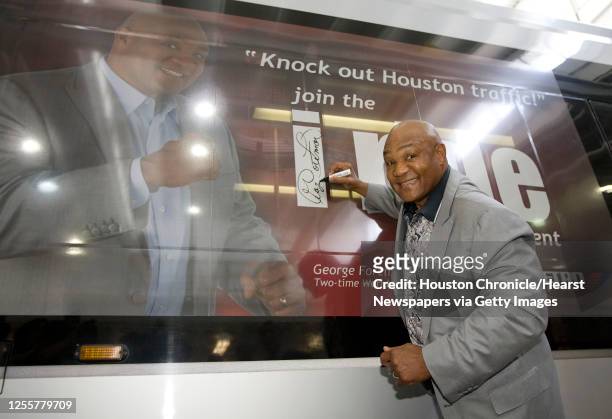 Two-time former heavyweight boxing champion George Foreman signs a Metro light rail train with his likeness for the new Metro promotion " i ride " at...