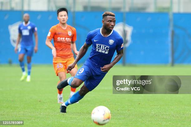 Oscar Taty Maritu of Shijiazhuang Yongchang drives the ball during a friendly match between Shijiazhuang Yongchang and Shandong Luneng Taishan on...