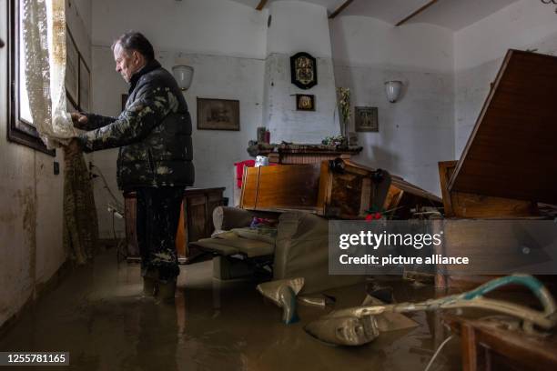 May 2023, Italy, Faenza: Local resident Guiseppe Beltrame stands in his living room after it has been devastated by a meters-high flood wave. Italy's...