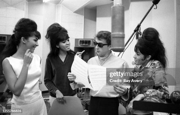 Vocal trio "The Ronettes" pose with producer Phil Spector while recording "A Christmas Gift for You from Phil Spector" at Gold Star Studios in 1963...