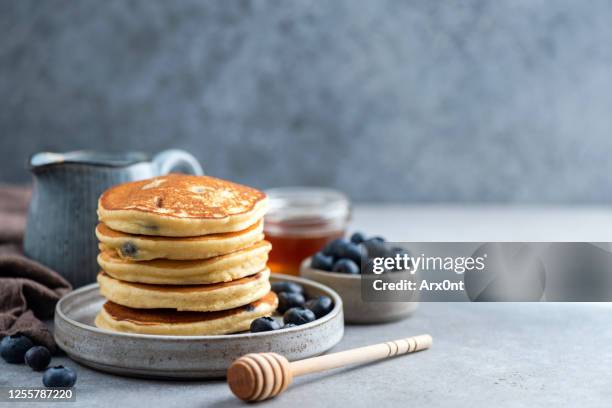 stack of pancakes with blueberries and honey - blueberry pancakes stock pictures, royalty-free photos & images