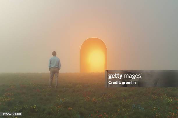 businessman standing in front of mysterious passage - time travel stock pictures, royalty-free photos & images