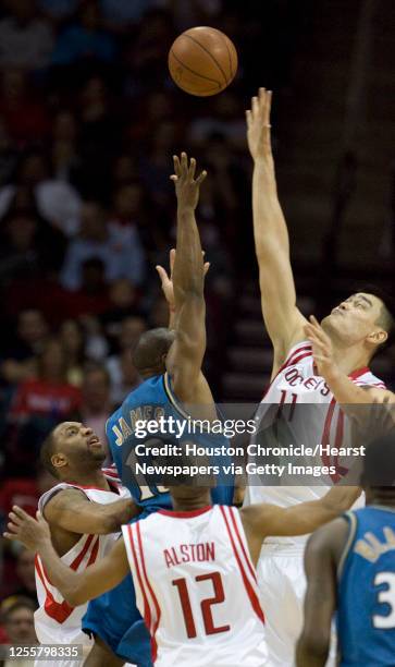 The Houston Rockets Tracy McGrady Rafer Alston and Yao MIng defend a shot the Washington Wizards Mike James during the third quarter of NBA game...