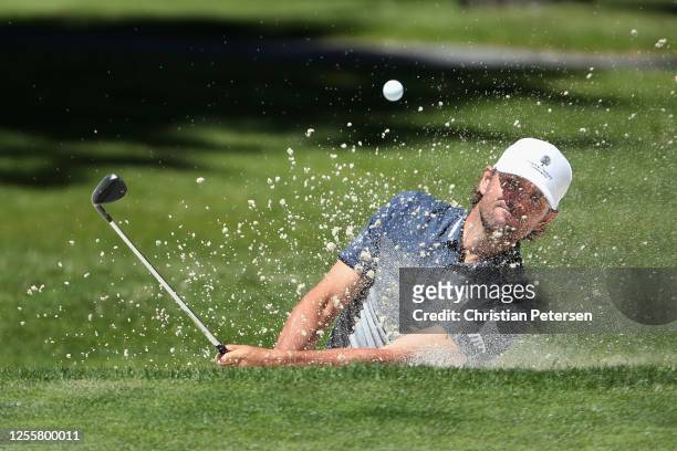 Former professional tennis athlete Mardy Fish chips from the bunker onto the 17th green during the final round of the American Century Championship...