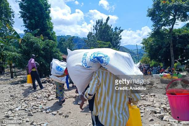 People receive humanitarian aid distributed by United Nations International Children's Emergency Fund in Kalehe territory of South Kivu province...
