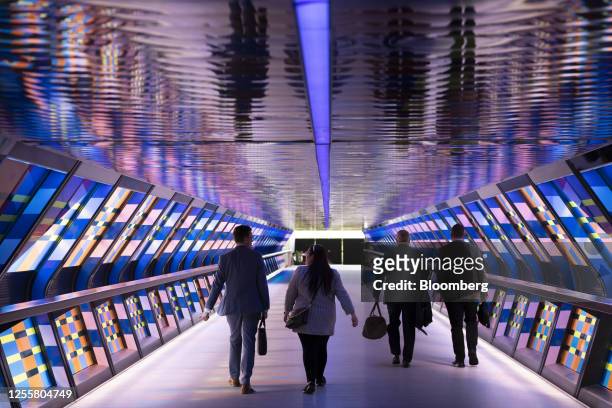 Workers walk through the Canary Wharf business district in London, UK, on Thursday, May 18, 2023. A series of rapid rates hikes has roiled UK...