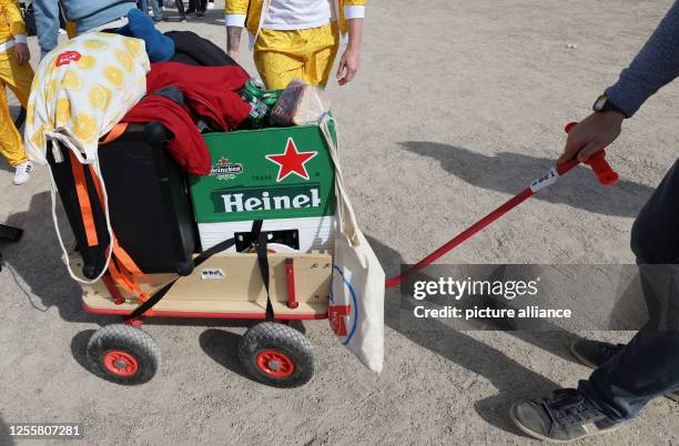 May 2023, Mecklenburg-Western Pomerania, Rostock: In the city harbor on the Warnow River, revelers are out and about with their "Bollerwagen" on...