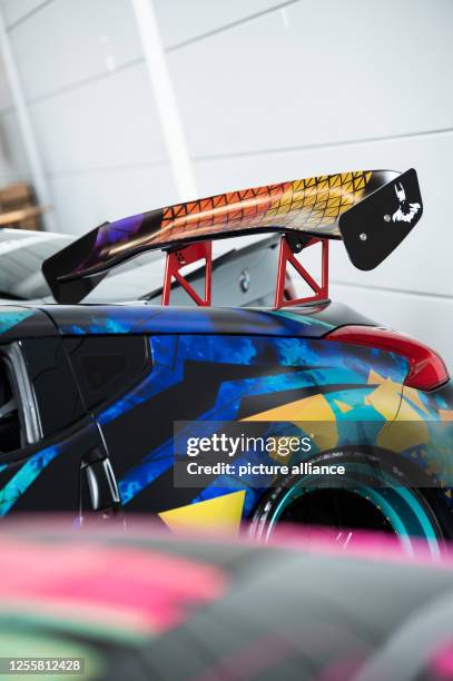 May 2023, Baden-Württemberg, Friedrichshafen: A rear spoiler of a Nissan is seen at Tuning World on the exhibition grounds of Messe Friedrichshafen....