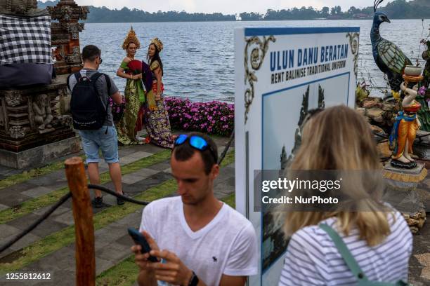 Tourists take pictures around Lake Beratan in Kintamani, Bali, Indonesia, on May 18, 2023.