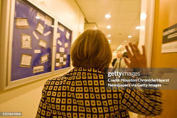 Abigail Young waves her arm in the air as she leaves a court hearing on the death of her four-year-old daughter Emma Thompson in the Harris County...