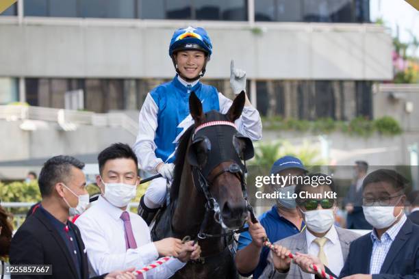 Jockey Jerry Chau Chun-lok and trainer Ricky Yiu Poon-fai celebrate after Super Oasis winning the Race 9 Hong Kong Racehorse Owners Association...