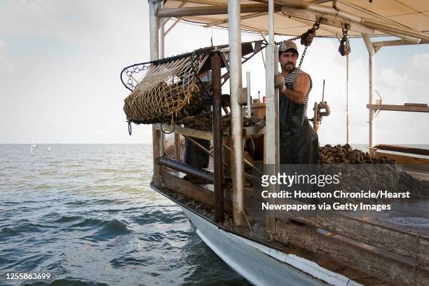 Javier Zendejas works abord Jeri's Seafood oyster boat Miss Britney on a reef in Galveston's East Bay Monday, Aug. 17 in Smith Point.