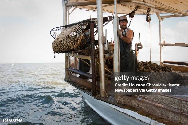 Javier Zendejas works abord Jeri's Seafood oyster boat Miss Britney on a reef in Galveston's East Bay Monday, Aug. 17 in Smith Point. SPECIAL SERIES:...