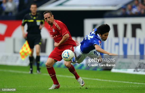 Franck Ribery of Muenchen challenges Atsuto Uchida of Schalke during the Bundesliga match between FC Schalke 04 and FC Bayern Muenchen at Veltins...