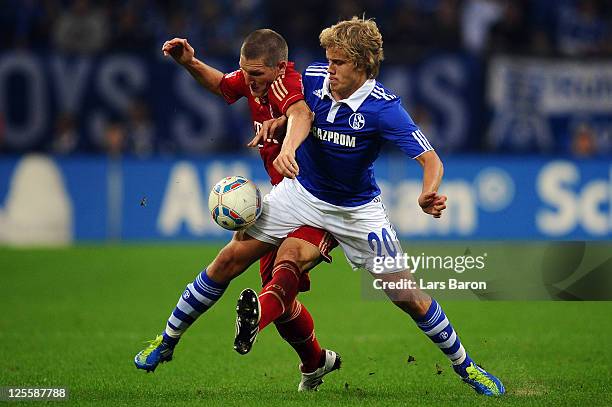 Bastian Schweinsteiger of Muenchen challenges Teemu Pukki of Schalke during the Bundesliga match between FC Schalke 04 and FC Bayern Muenchen at...