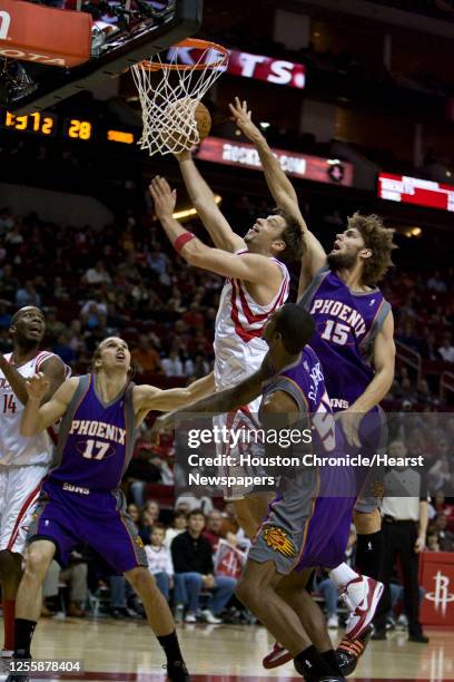 The Houston Rockets David Andersen shoots the ball over the Phoenix Suns Louis Amundson , Earl Clark and Robin Lopez during the second quarter of NBA...