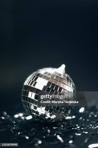 silver disco ball on a black background with serpentine. - silver disco ball stock pictures, royalty-free photos & images