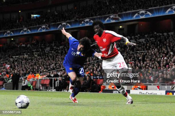 Emmanuel Adebayor of Arsenal and Rafael of Manchester United compete for the ball during the UEFA Champions League semi final second leg match...