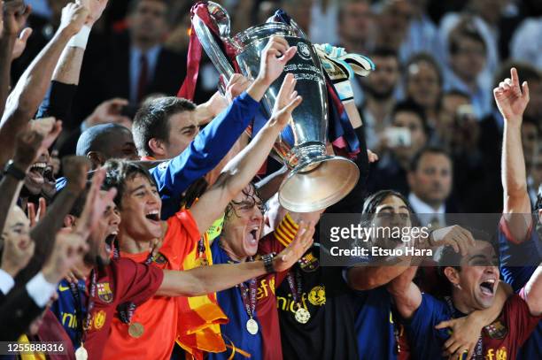 Captain Carles Puyol of Barcelona lifts the trophy at the medal ceremony after the UEFA Champions League final between Barcelona and Manchester...