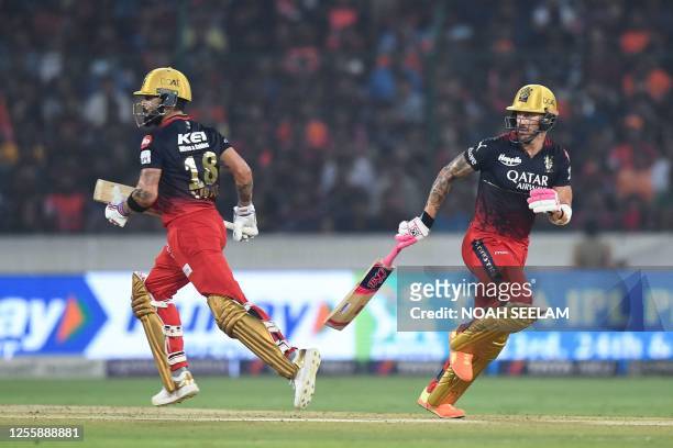 Royal Challengers Bangalore's Faf du Plessis and Virat Kohli run between the wickets during the Indian Premier League Twenty20 cricket match between...