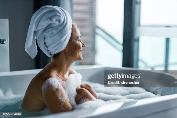 happy woman enjoying in her bubble bath. - woman shower bath imagens e fotografias de stock