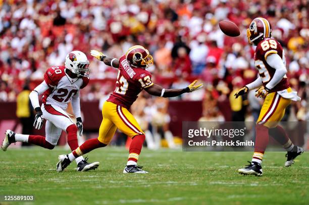 Wide receiver Anthony Armstrong of the Washington Redskins and corner back A.J. Jefferson of the Arizona Cardinals watch a tipped pass that would be...