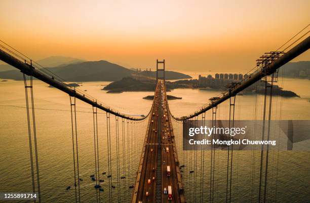 aerial view of traffic of car at tsing ma bridge in tsing yi area of hong kong at sunset. - novos territórios imagens e fotografias de stock