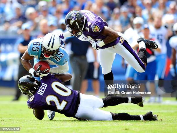 Ed Reed and Domonique Foxworth of the Baltimore Ravens tackle Nate Washington of the Tennessee Titans during the first half at LP Field on September...