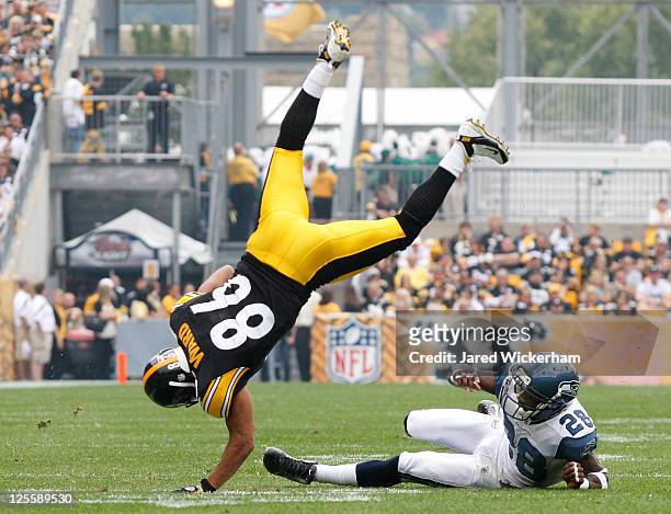 Hines Ward of the Pittsburgh Steelers is flipped over Walter Thurmond of the Seattle Seahawks after catching a pass in the first half during the game...