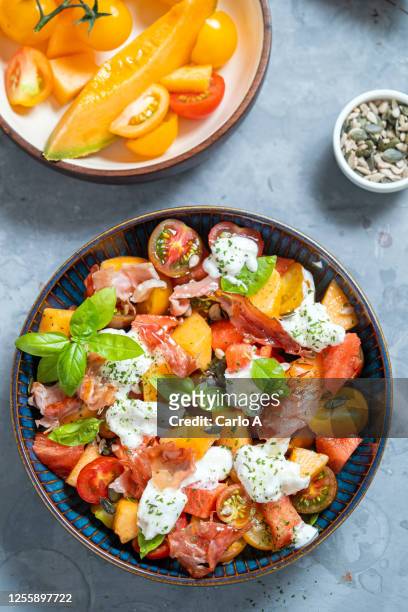 summer salad with fruits, tomatoes, burrata cheese and ham - burrata stock pictures, royalty-free photos & images