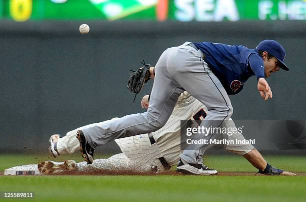 Michael Cuddyer of the Minnesota Twins steals second base as the ball gets by shortstop Jason Donald of the Cleveland Indians in the first inning at...