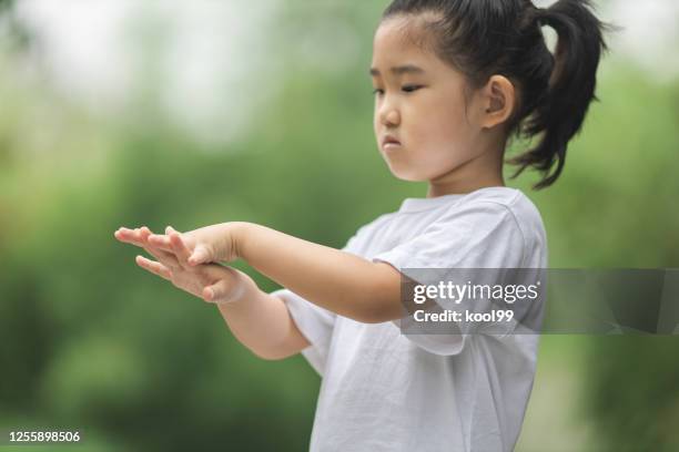 asian little girl emphasis washing hands for covid-19 - washing hands close up stock pictures, royalty-free photos & images
