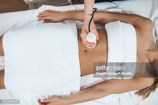 beautiful young adult woman at medical and beauty treatment - fat massage stock pictures, royalty-free photos & images