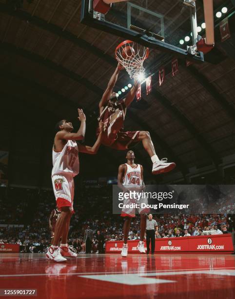 Antwuan Dixon, Forward for the Florida State Seminoles makes a slam dunk to the basket to score as Terence Morris and Drew Nicholas of the University...