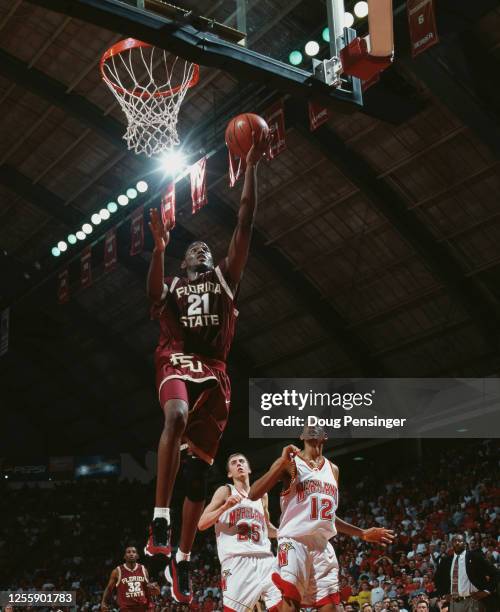 Ron Hale, Forward for the Florida State Seminoles makes a one handed layup to the basket to score as Steve Blake and Drew Nicholas of the Maryland...