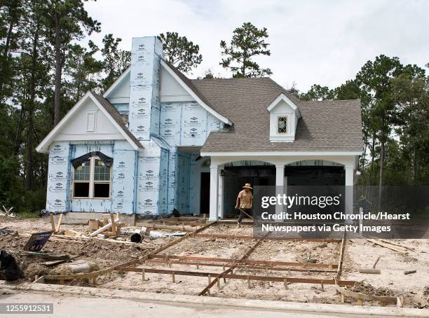 David Weekley home under construction in the Eagle Springs subdivision Wednesday, July 28 in Humble . Houston area home starts and sales are up in...