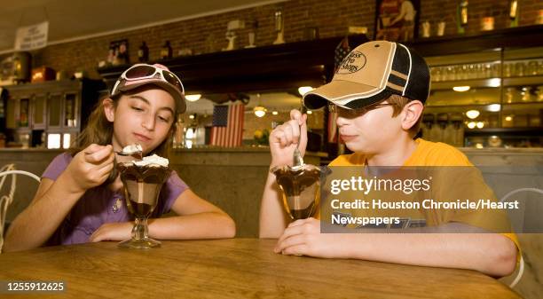 Lauren Hingle and her brother Kenney Hingle of Baton Rouge, Louisiana eat ice cream sundaes at La King's Confectionery Thursday, July 29 in Galveston...