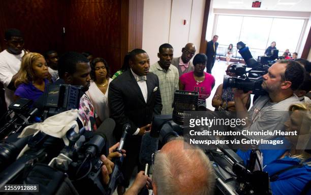 Activist Quanell X is surrounded by family and friends of Shatavia Anderson after a hearing for Melvin Alvarado, 22 and Jonathan Lopez-Torres who are...