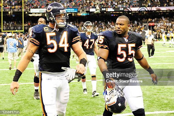 Brian Urlacher and Lance Briggs of the Chicago Bears walk off the field after being defeated 30-13 by the New Orleans Saints at the Louisiana...