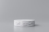 White marble product display on gray background with modern backdrops studio. Empty pedestal or podium platform. 3D Rendering.