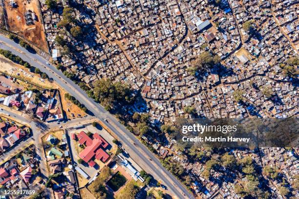 aerial view of inequality.  wealthy housing along side the makause informal settlement in primrose, south africa - south africa aerial stock pictures, royalty-free photos & images