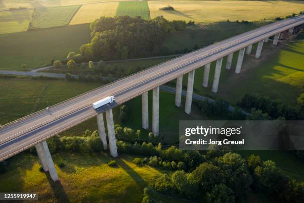 truck driving on autobahn bridge - rheinland pfalz stock-fotos und bilder