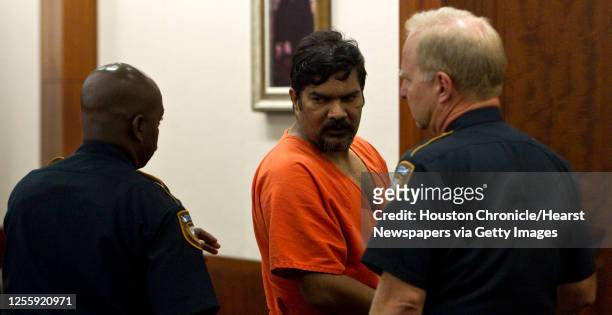 Vijay Kumar speaks with the court baliffs after pleading no contest to carrying brass knuckles in his checked airline baggage in Judge David...