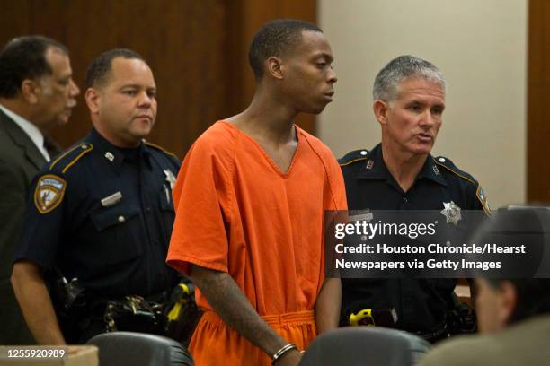 Curtis Odette Robinson is escorted after appearing in Judge Mark Kent Ellis' 351st State District Court by bailiffs Tuesday,Aug. 17 in Houston....