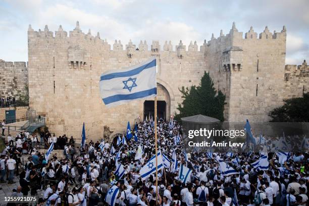 Ultranationalist Israeli jews hold the Israeli flag as they are marching in Jerusalem's old city muslim quarter on May 18, 2023 in Jerusalem, Israel....